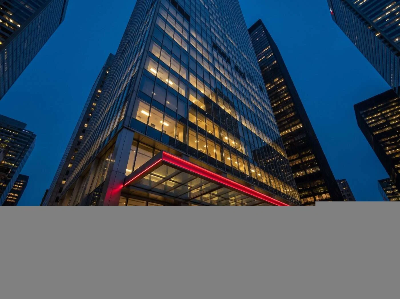 Tour de banque de verre dans le quartier financier de Toronto à l'heure bleue, avec un auvent de hall d'entrée éclairé en rouge cramoisi
